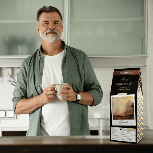 Single-origin specialty coffee from Peru in collectible GEORGE National Parks Collection packaging by Official Fellow Citizen. Scene of man holding cup of coffee in background. - Certified by Mintall.