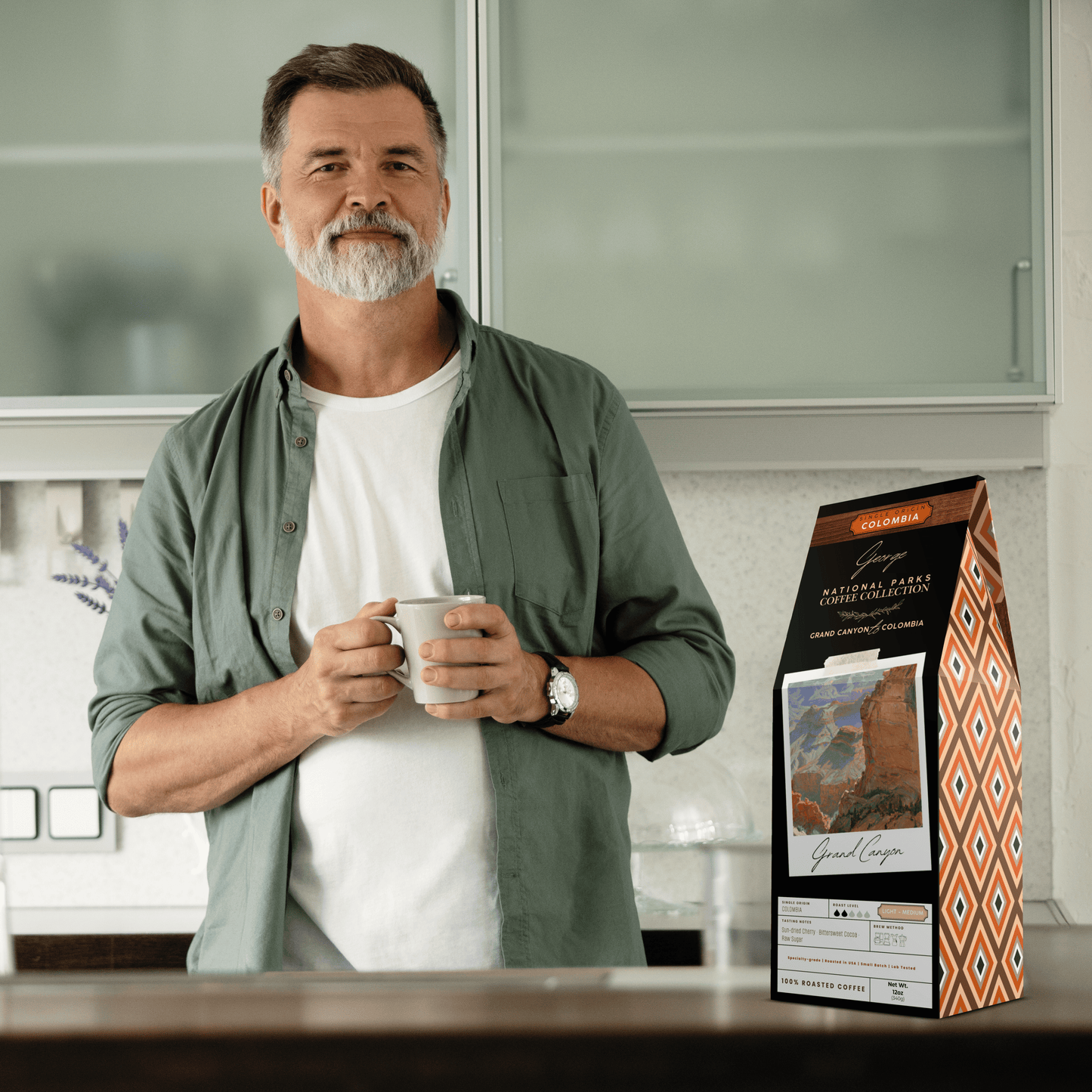 Single-origin specialty coffee from Colombia in collectible GEORGE National Parks Collection packaging by Official Fellow Citizen. Scene of man holding coffee cup in kitchen. - Certified by Mintall.