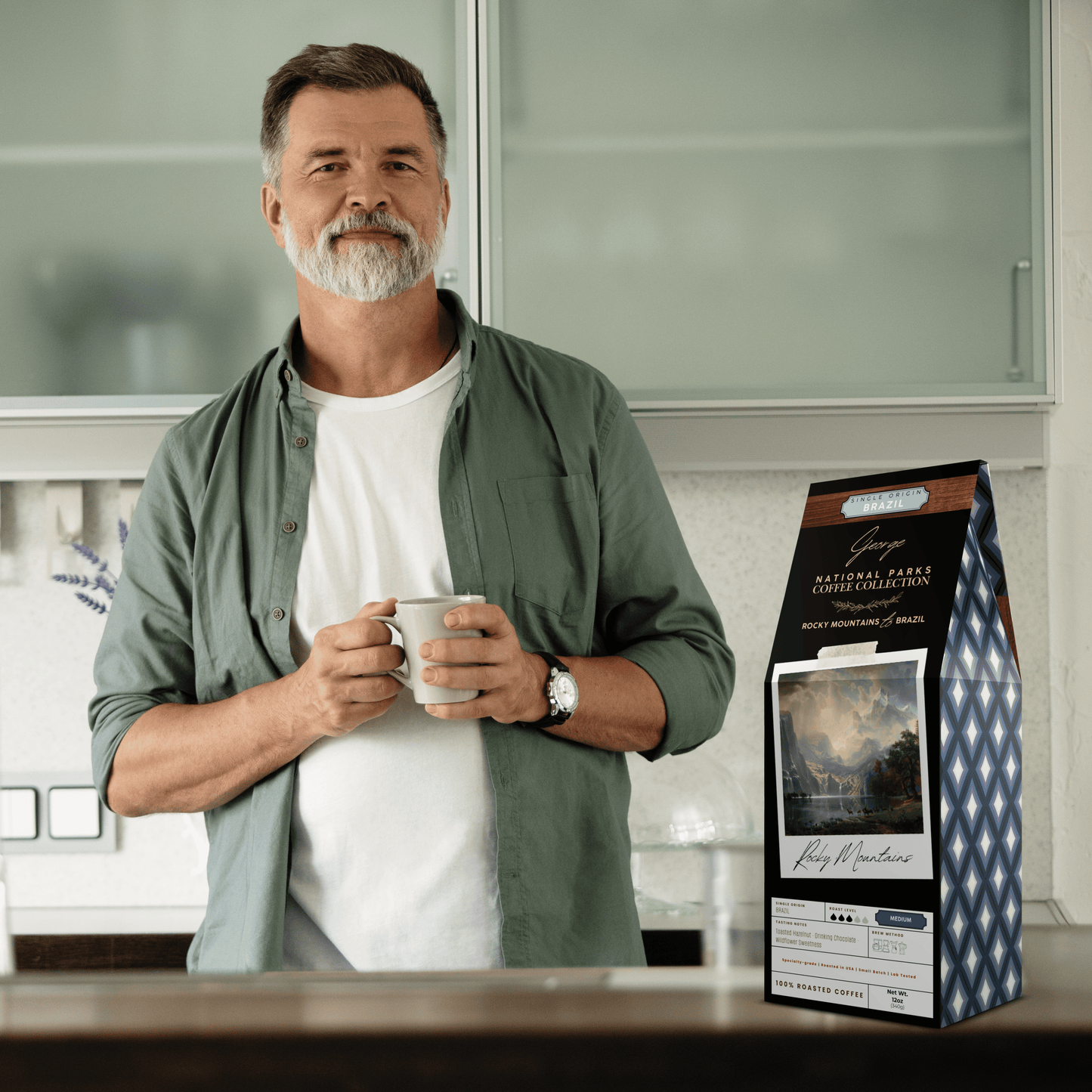 Single-origin specialty coffee from Brazil in collectible GEORGE National Parks Collection packaging by Official Fellow Citizen. Scene of man holding coffee mug in kitchen. - Certified by Mintall.